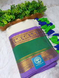 Green and purple fabric with gold patterns and a brand label, placed on a white surface with green plants in the background.