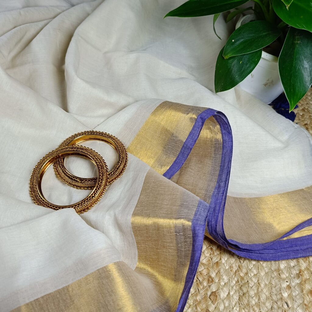 Bengal Mull Cotton Saree, featuring a striking contrast zari border and playful pompom edging
